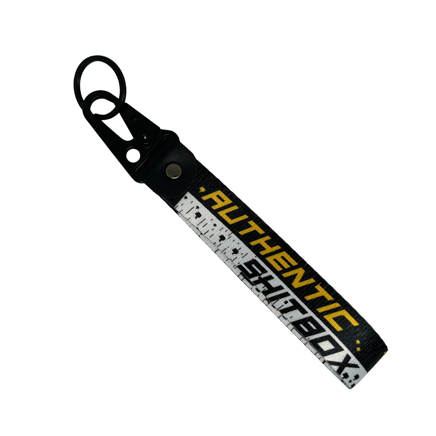 Front side of a black, white and yellow keychain with gritty design reading "Authentic Sh*tbox" – Motorev automotive keychain accessory