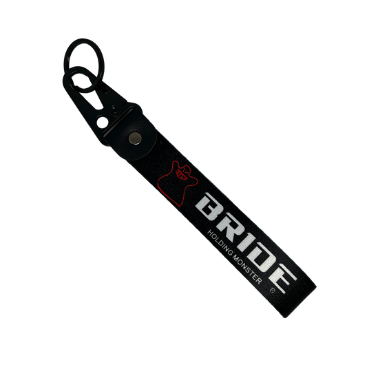 Black key tag with BRIDE HOLDING MONSTER branding in white print – Motorev embroidered car keychain