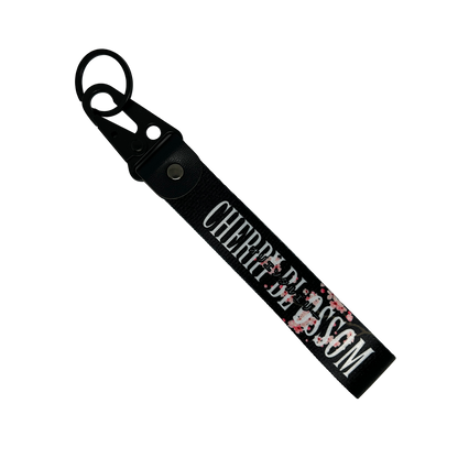Black key tag with a floral cherry blossom design and cherry clossom in text – Motorev car accessory