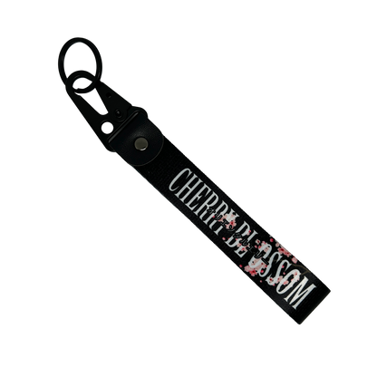 Black key tag with a floral cherry blossom design and cherry clossom in text – Motorev car accessory