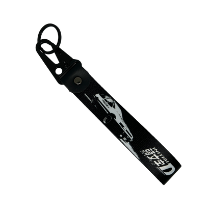 Black key tag with a Toyota AE86 and the Initial D manga logo – Motorev automotive keychain accessory