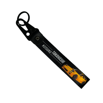 Motorev Initial D Keisuke Takahashi car key tag, a zinc alloy and nylon JDM keyring featuring the iconic Akagi RedSuns Mazda RX-7 driver, scratch resistant and built for JDM and anime car culture enthusiasts UK