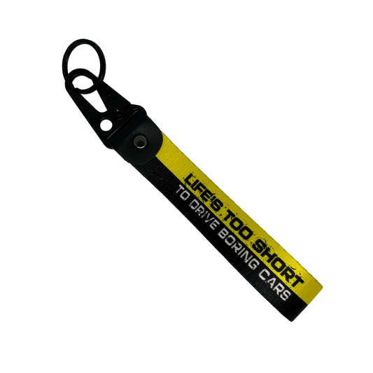 Black and yellow key tag with "Life's too short to drive boring cars" text – Motorev JDM car accessory