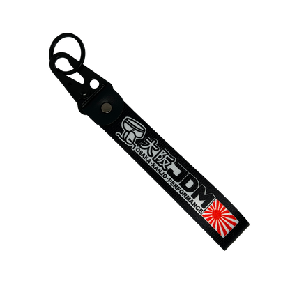 Black key tag with Japanese print, a sunrise logo and he test "JDM" – Motorev embroidered car keychain