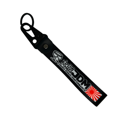 Black key tag with Japanese print, a sunrise logo and he test "JDM" – Motorev embroidered car keychain