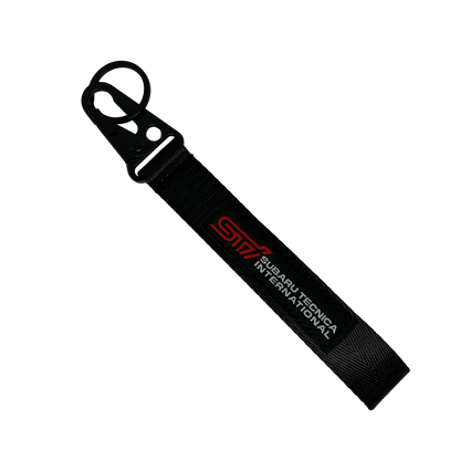 Motorev Subaru STI embroidered car key tag, a wrist strap keyring featuring the iconic STI logo stitched in detail, built for Subaru and JDM enthusiasts UK